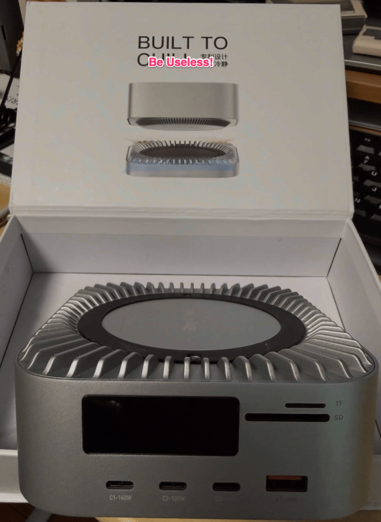 Photo of RayCue Mac Mini doc with logo changed to "Built to be useless"